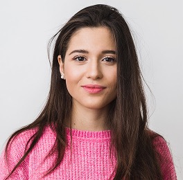 Photo of the team member 3. Woman in a pink sweater.